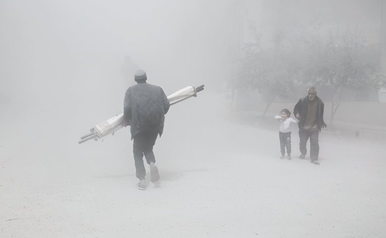 Местные жители во время воздушных ударов в пригороде Дамаска