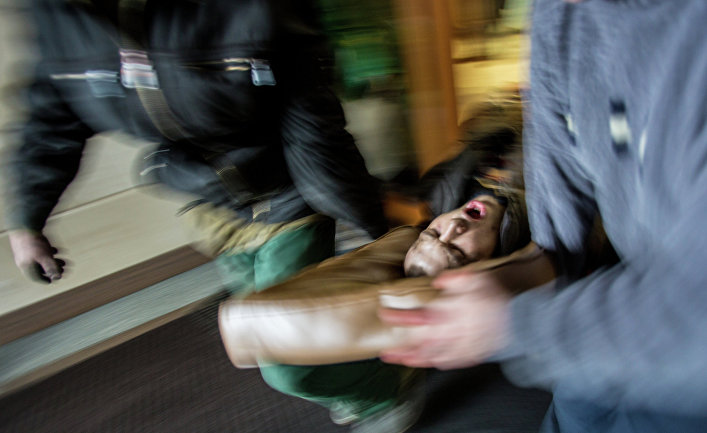 Сторонники оппозиции несут раненного во время столкновений с сотрудниками правопорядка на площади Независимости в Киеве