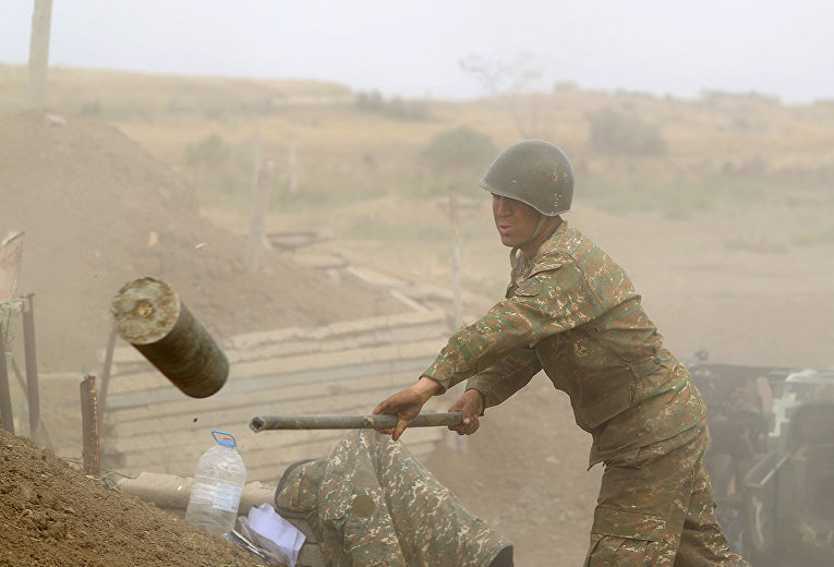Армянский солдат стреляет из артиллерийского орудия