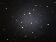 Наблюдения NGC 1052-DF2 показали необычно малое содержание тёмной материи Наблюдения NGC 1052-DF2 показали необычно малое содержание тёмной материи