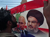 Живущий в Ливане сириец целует плакат с изображением Владимира Путина и Хасана Насраллы во время митинга в Бейруте