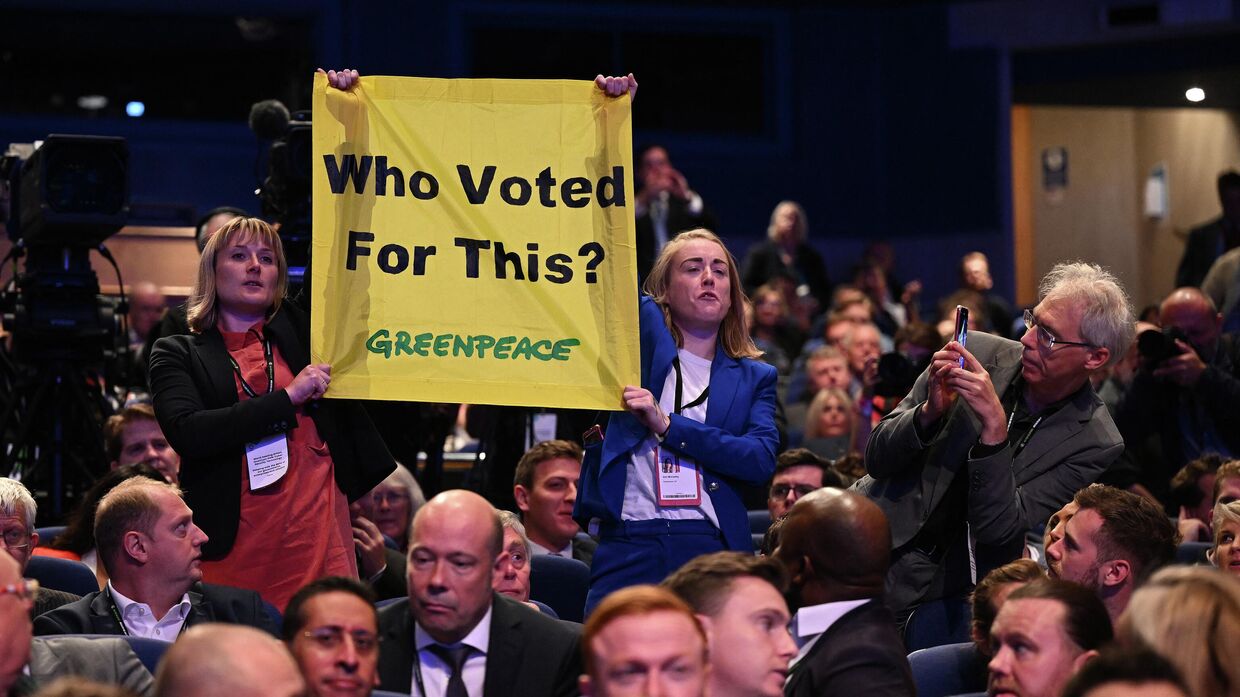 Экоактивисты из организации Гринпис прервали выступление Лиз Трасс c плакатом Кто за это голосовал? в Бирмингеме, 5 октября 2022 года