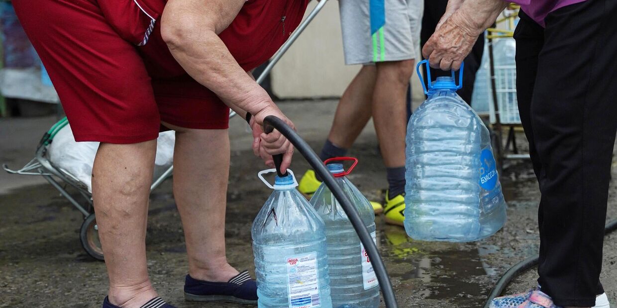 Местная жительница набирает питьевую воду 