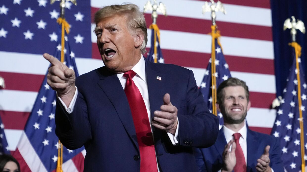 Кандидат в президенты от республиканской партии, бывший президент Дональд Трамп выступает на митинге своих сторонников в Де-Мойне, штат Айова, 15 января 2024 года. Справа его сын Эрик