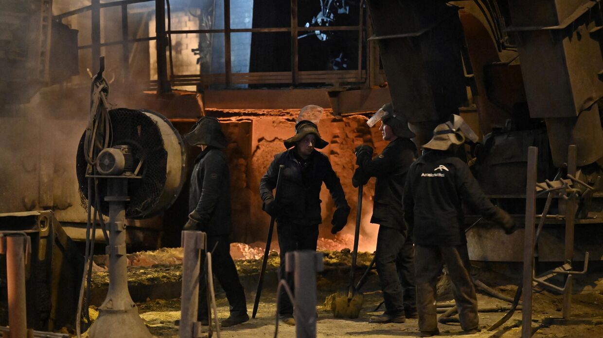 Рабочие у доменной печи на заводе объединенной сталелитейной компании ArcelorMittal в городе Кривой Рог, Украина