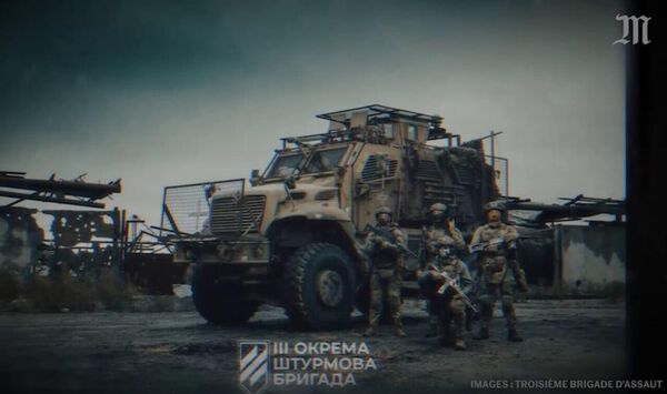 Боевики Азова позируют рядом с американской бронемашиной MRAP