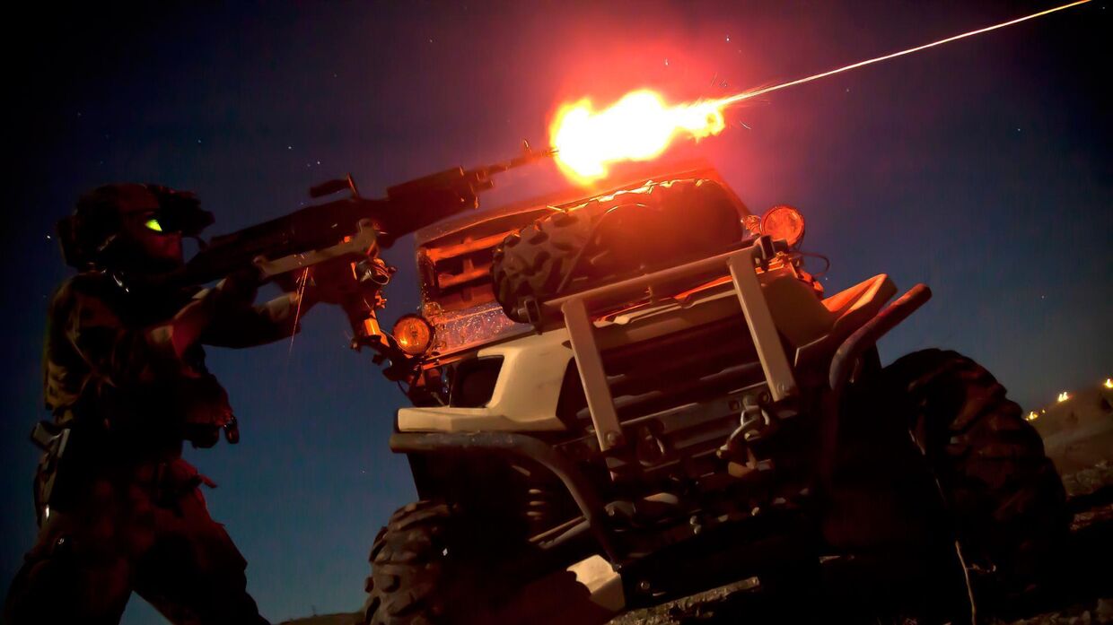 Морпех из команды спецопераций стреляет из пулемета M240B во время ночной тренировки в Афганистане