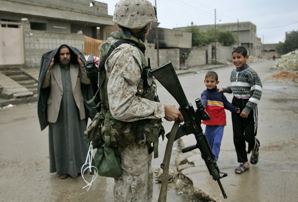 Американский солдат патрулирует улицу в Эль-Фаллудже в Ираке