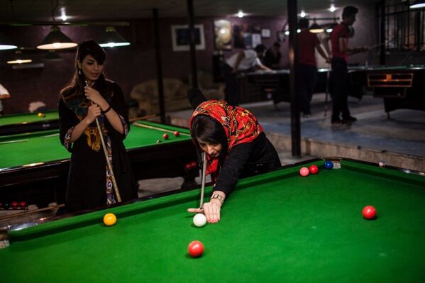 Женщины играют на бильярде в клубе в Тегеране
