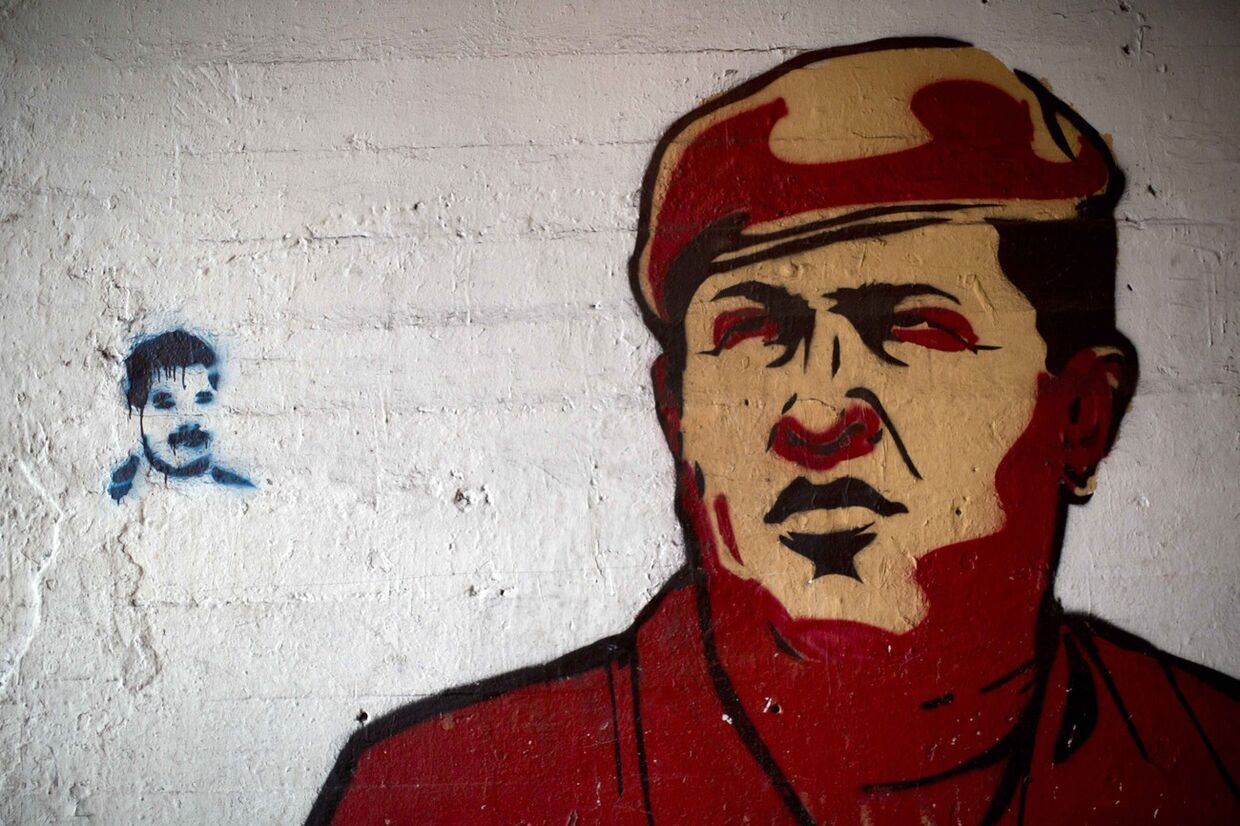 Портреты Уго Чавеса и Николаса Мадуро на стене в Каракасе