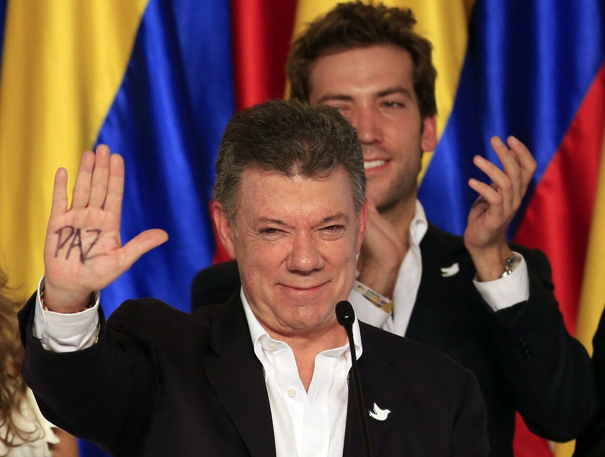 Хуан Мануэль Сантос после переизбрания на президентских выборах, на ладони написано слово «мир»
