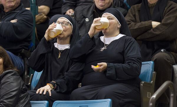 Женщины в платьях монахинь пьют пиво на чемпионате по керлингу