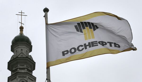 Флаг с логотипом компании «Роснефть» на фоне церкви в Москве Флаг с логотипом компании «Роснефть» на фоне церкви в Москве