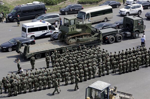 Военная полиция на месте взрывов на складе опасных веществ в промышленном городе Тяньцзине в Китае 