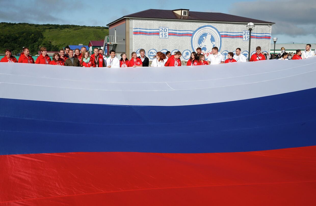 Председатель правительства России Дмитрий Медведев фотографируется с участниками всероссийского молодежного образовательного форума Итуруп в городе Курильске