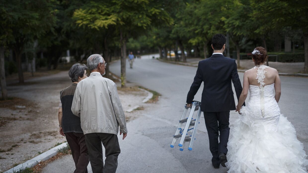 Молодожены и пожилая пара на прогулке в Афинах