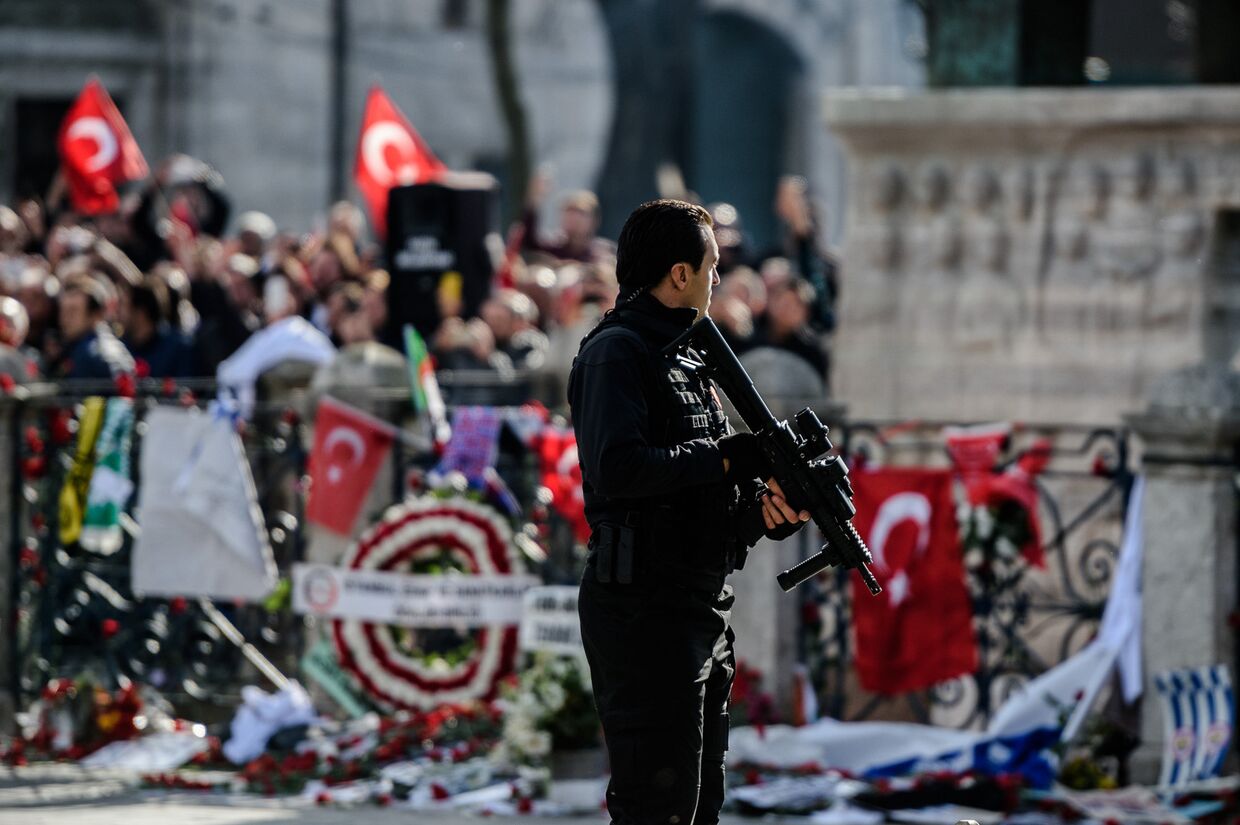 Полицейский рядом с памятником жертвам теракта на площади Султанахмет в Стамбуле