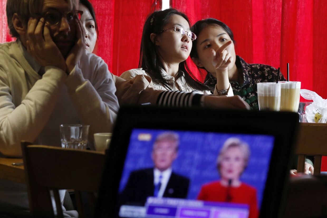 Люди смотрят трансляцию дебатов между Дональдом Трампом и Хиллари Клинтон