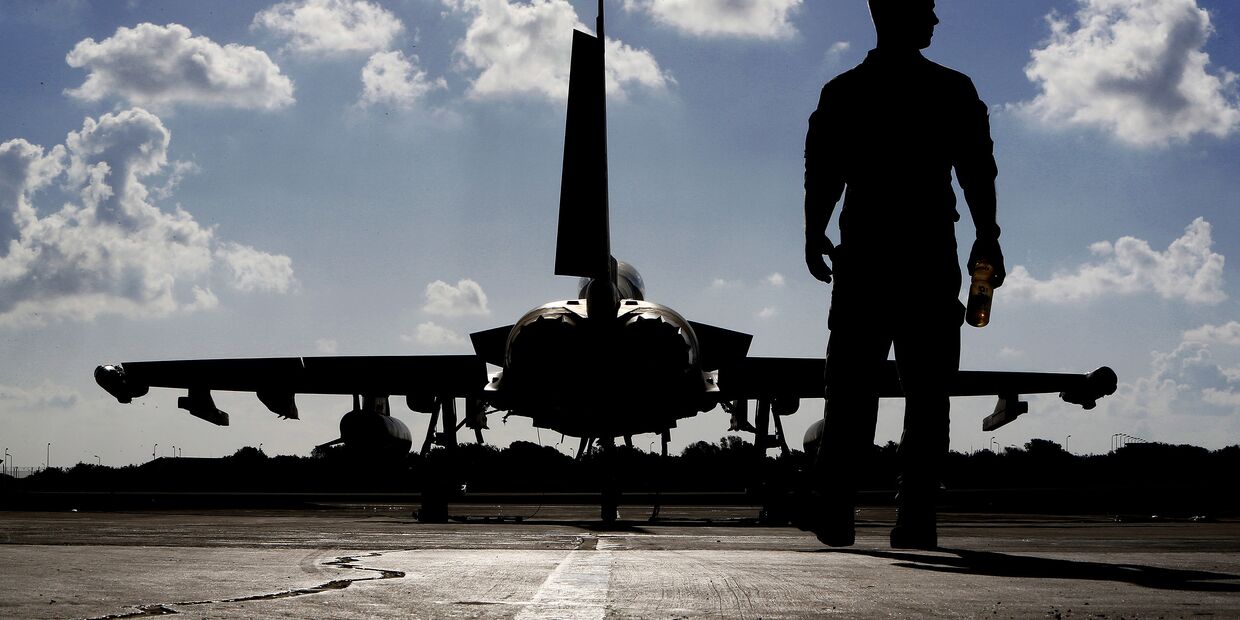 Британский военный возле истребителя «Тайфун» перед взлетом в Ирак