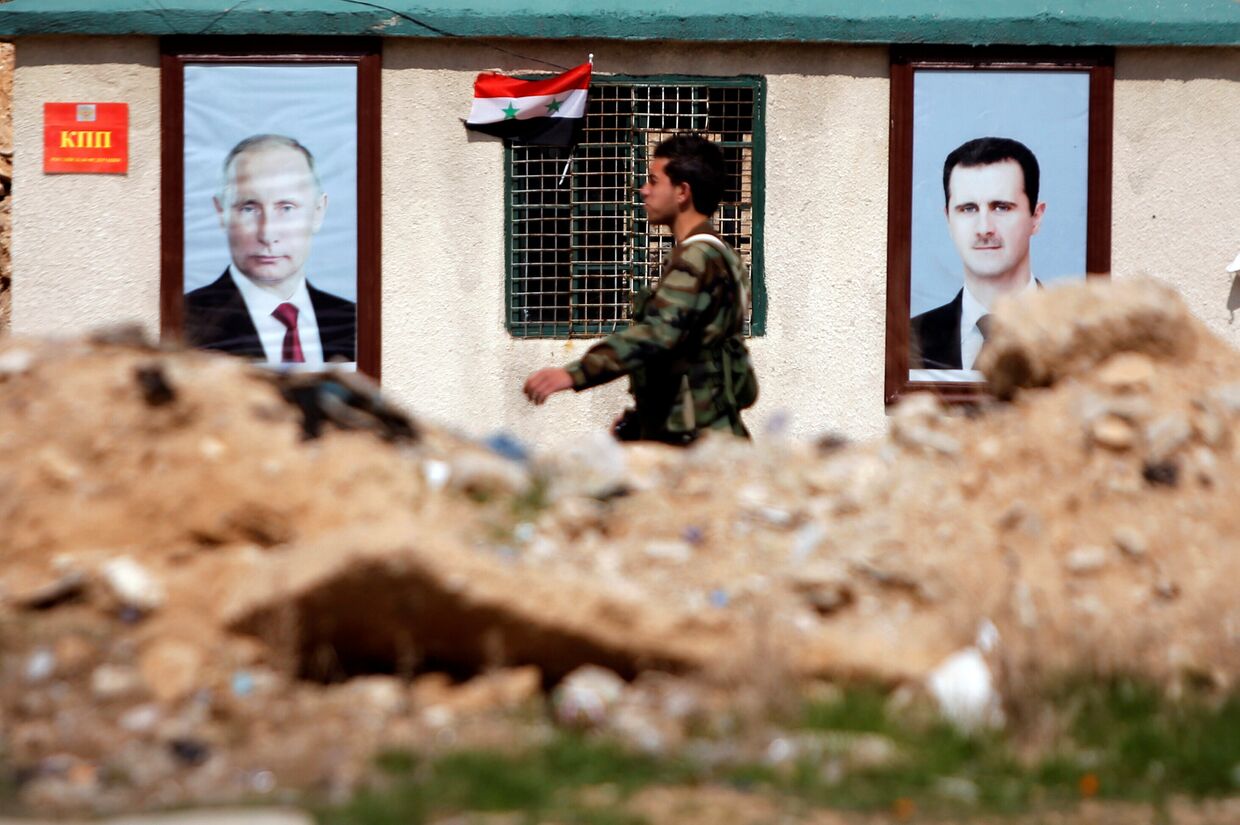 Портреты президента РФ Владимира Путина и президента Сирии Башара Асада на улице в Восточной Гуте