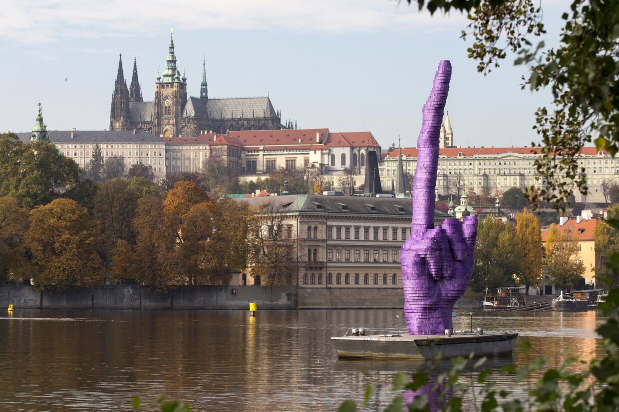 Скульптура в виде фрагмента руки с вытянутым вверх 10-метровым средним пальцем на понтоне на реке Влтава напротив Пражского Града