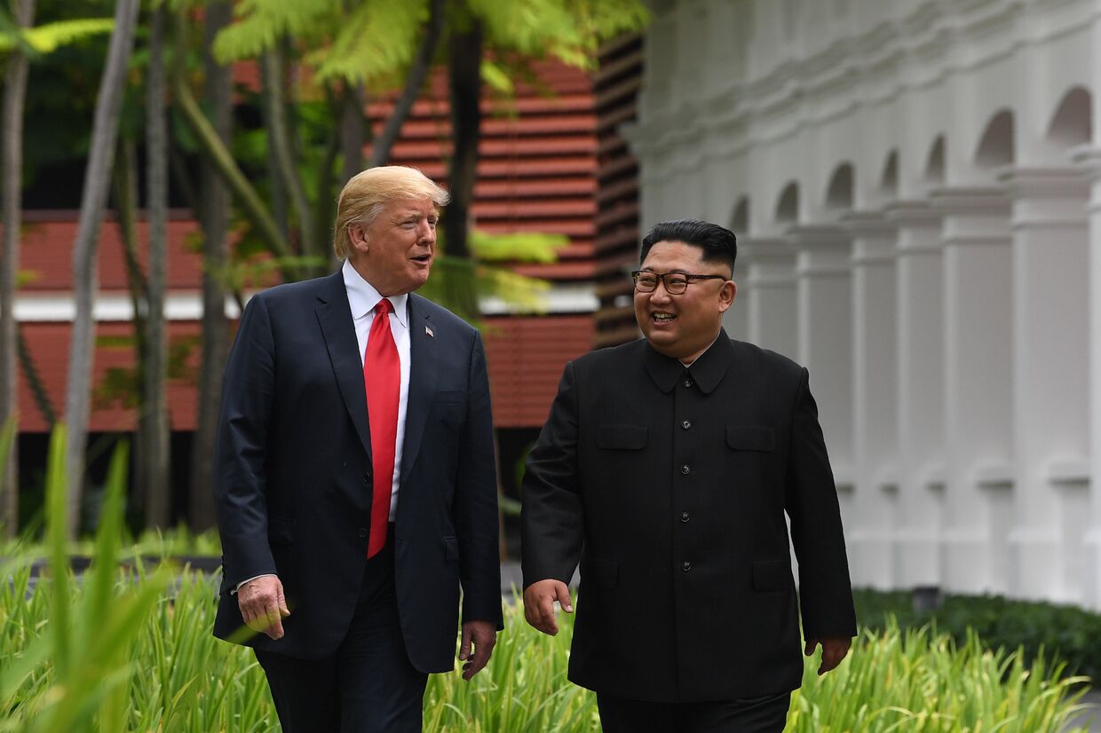 Президент США Дональд Трамп и лидер КНДР Ким Чен Ын Во время прогулки у отеля Капелла в Сингапуре. 12 июня 2018