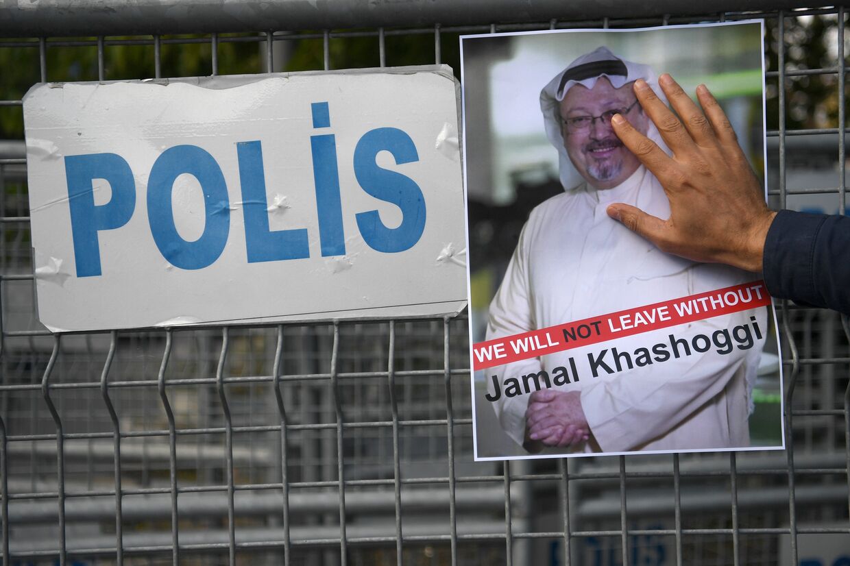 Участник акции протеста с портретом саудовского журналиста Джамаля Хашукджи у здания консульства Саудовской Аравии в Стамбуле, Турция