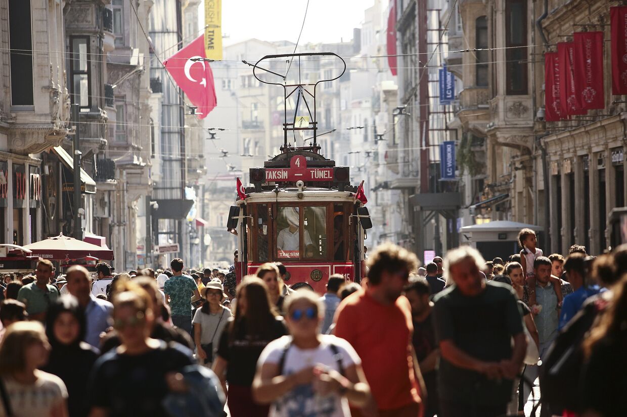 Люди гуляют по главной торговой улице Стамбула
