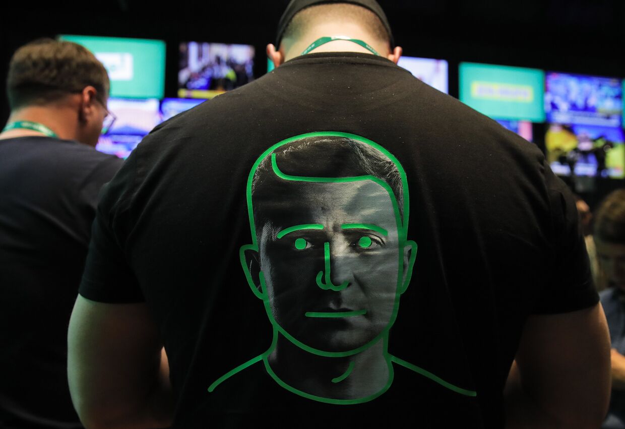 Мужчина в футболке с портретом Владимира Зеленского на спине
