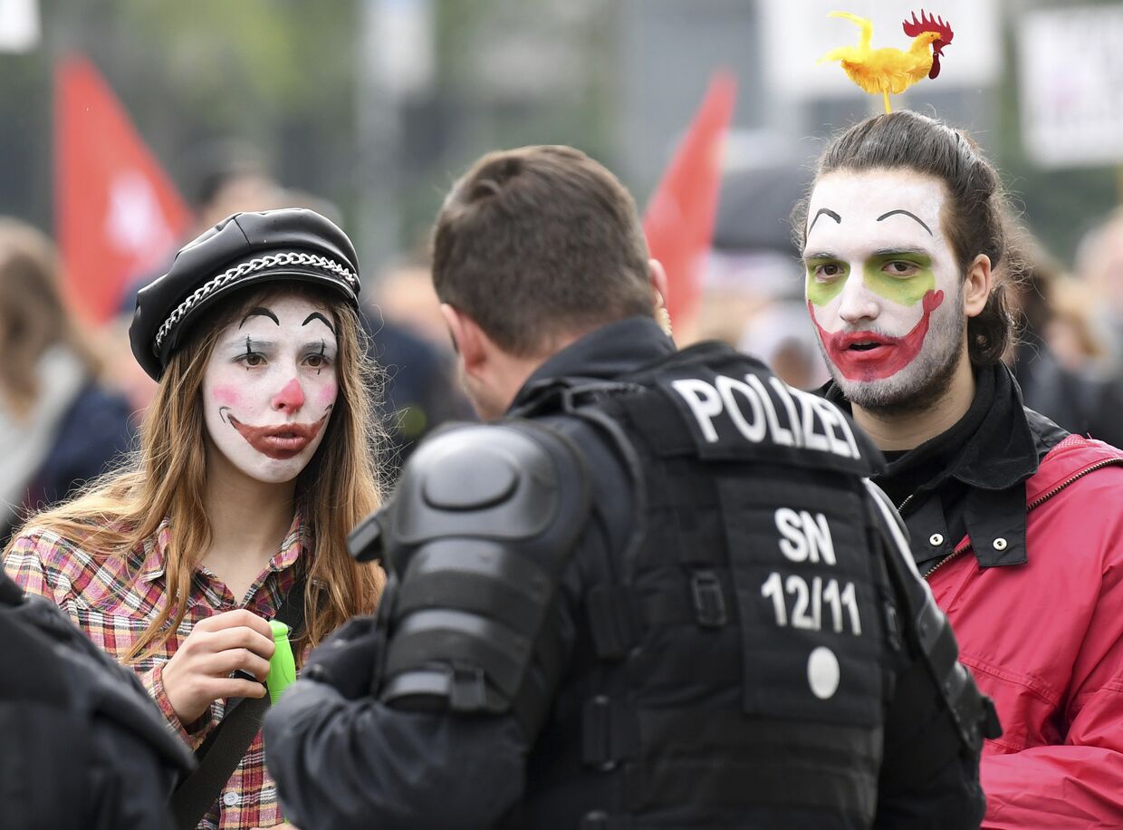 Участники акции протеста против расизма в Хемнице, Германия, разговаривают с полицейским