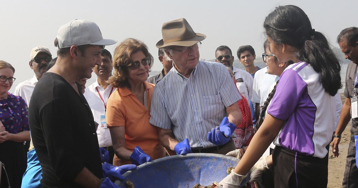 Король Швеции Карл XVI Густав во время уборки пляжа в Мумбаи, Индия