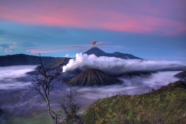 Вулкан Семеру извергается на острове Ява в Индонезии. На переднем плане вулканы Баток и Бромо