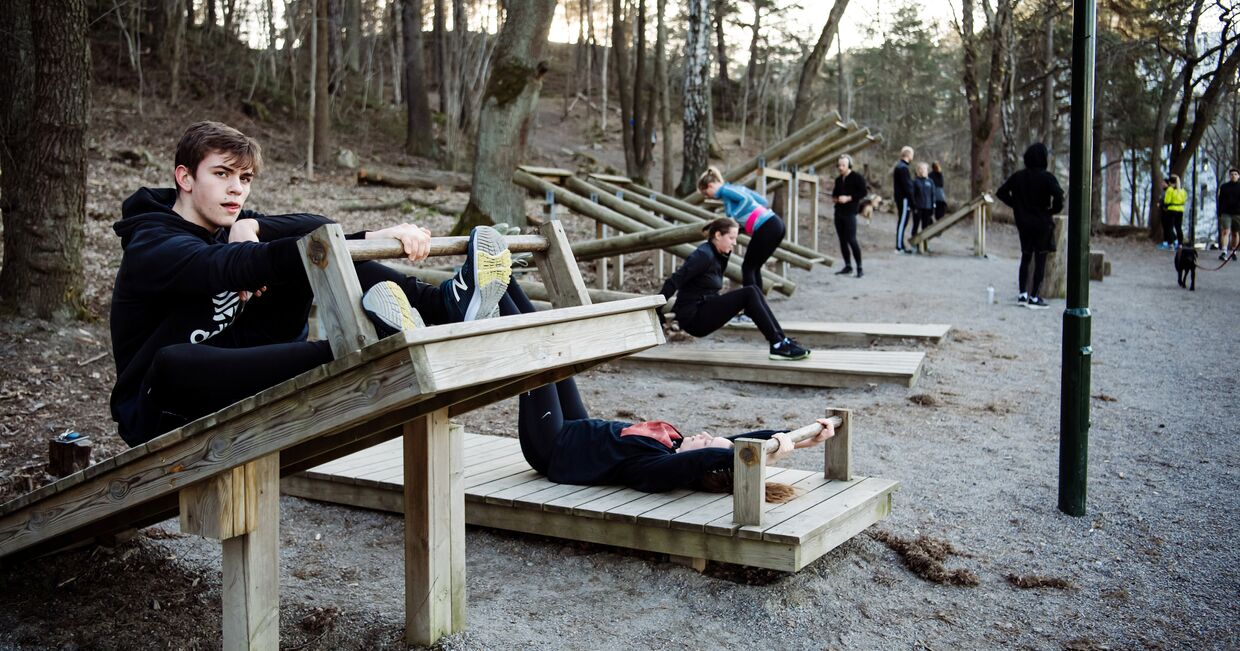 Молодые люди упражняются в парке, Стокгольм, Швеция