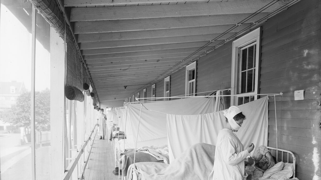 Медсестра ухаживает за пациентом во время эпидемии испанки, 1918-1919
