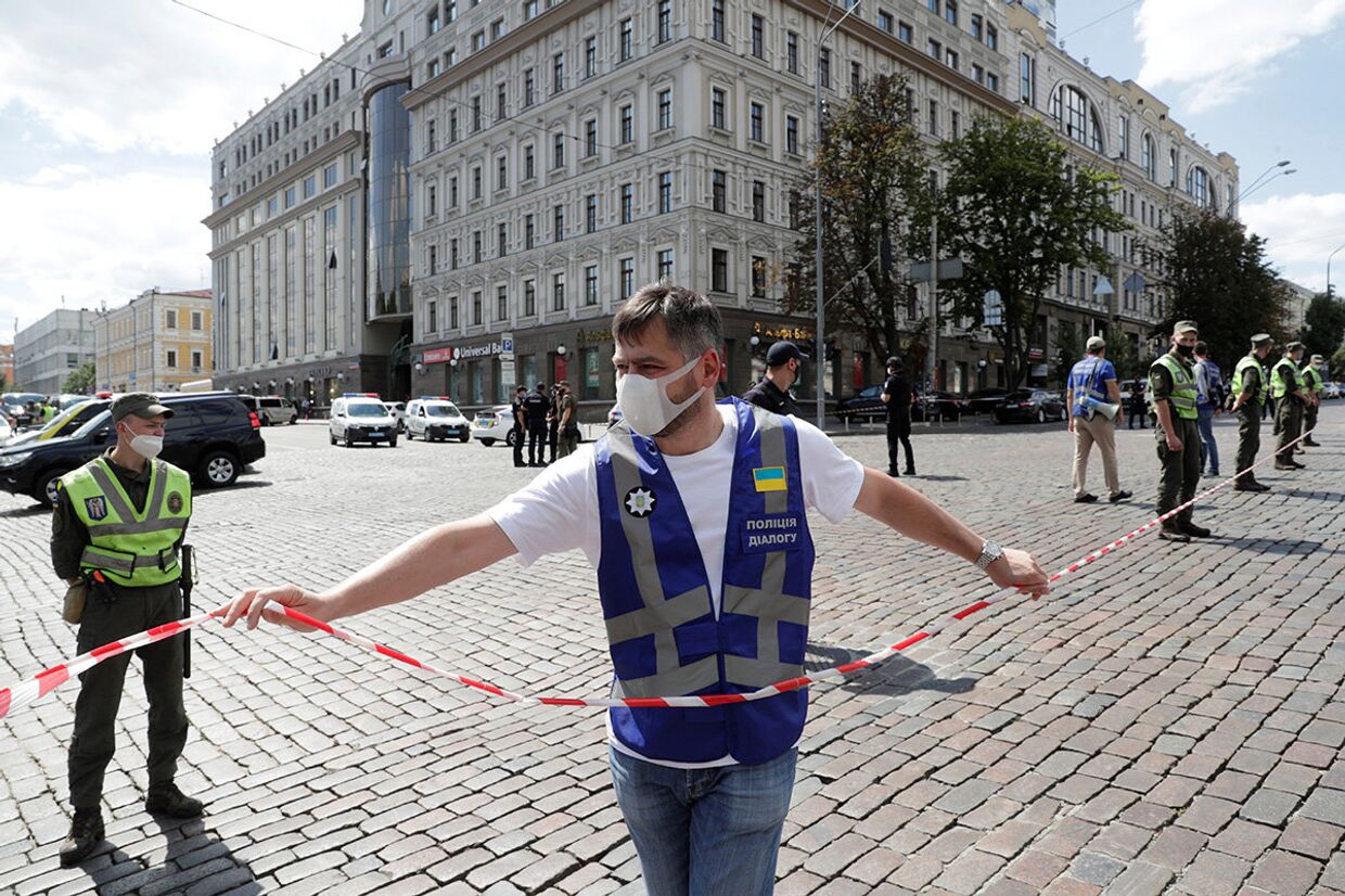 Сотрудники правоохранительных органов у отделения банке в Киеве, где неизвестный угрожает взорвать бомбу
