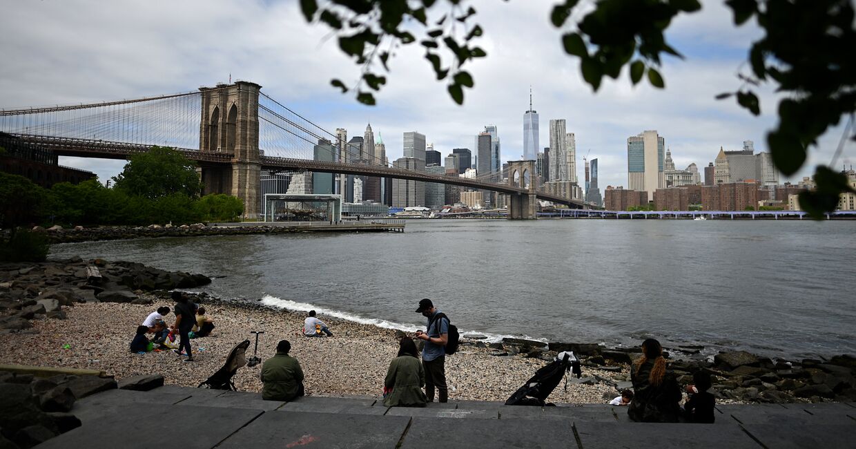 22 мая 2020. Люди на пляже в Нью-Йорке с видом на Манхеттен и Бруклинский мост