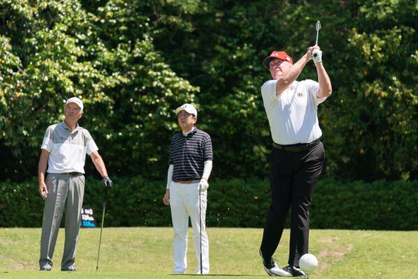 President Donald J. Trump, joined by Japan Prime Minister Shinzo Abe and Hall of Fame professional golfer Isao Aoki, watches his tee shot during their golf game Sunday, May 26, 2019, at the Mobara Country Club in Chiba, Japan.