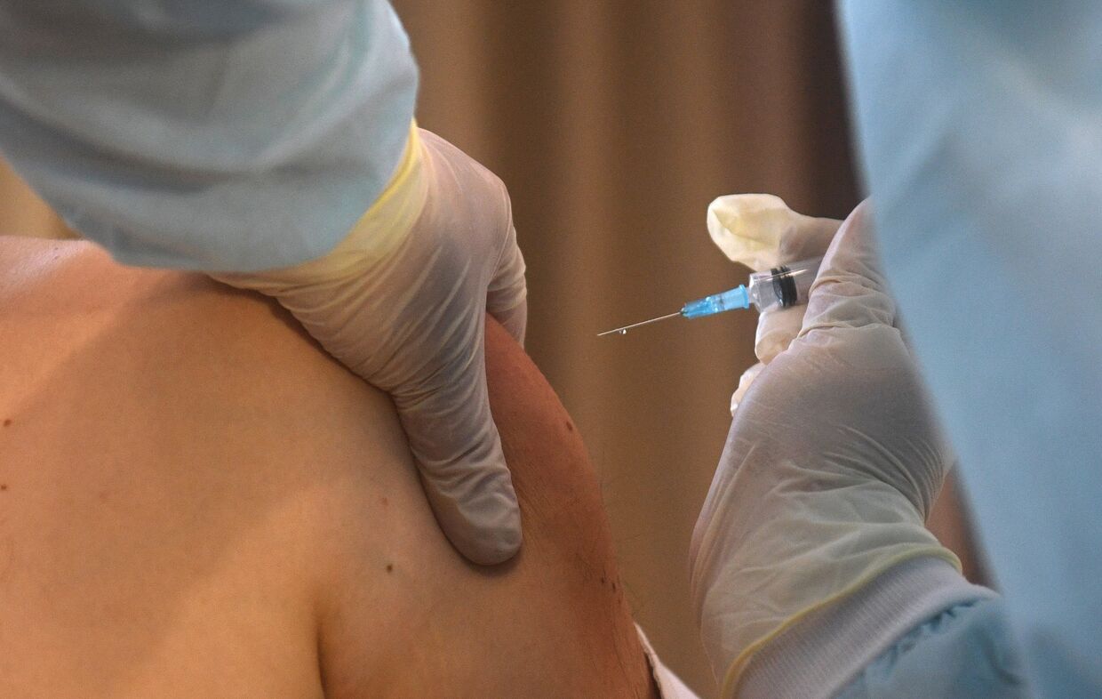 Медицинский сотрудник делает прививку от COVID-19